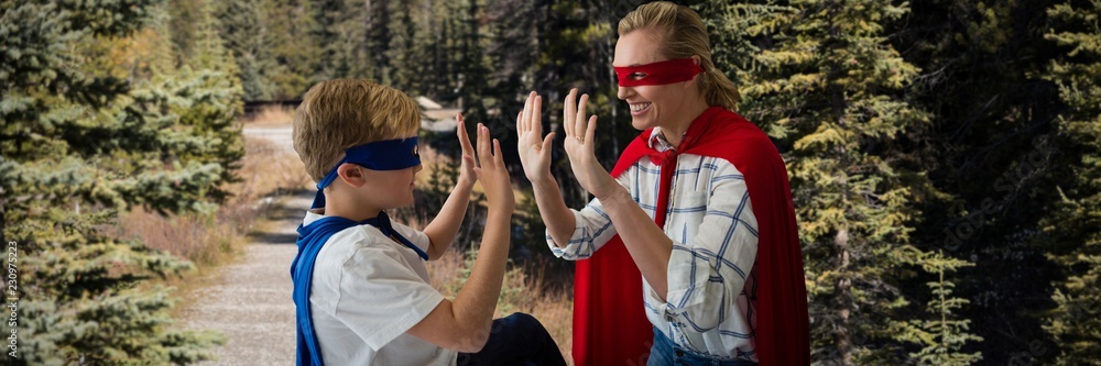 Composite image of mother and son pretending to be superhero