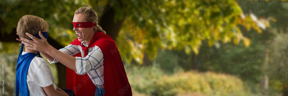 Composite image of mother and son pretending to be superhero