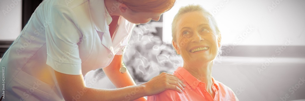 Female nurse consoling senior woman 