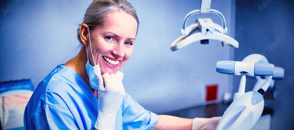 Dental assistant examining young patient mouth