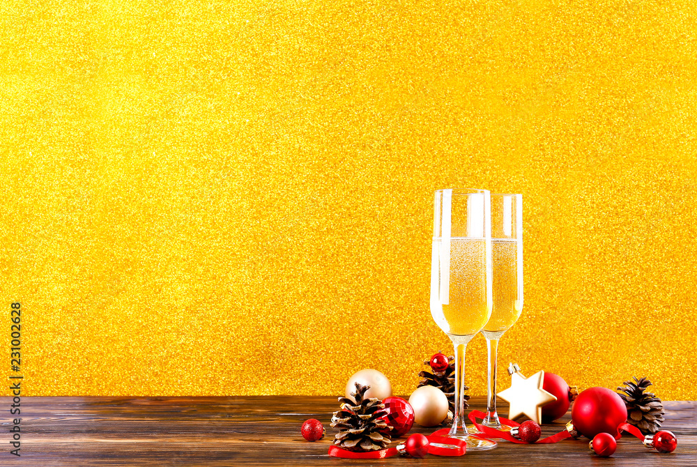 Beautiful christmas composition with two glasses of sparkling wine, decorations on wood textured tab