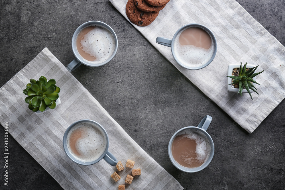 Cups with tasty aromatic coffee on grey table