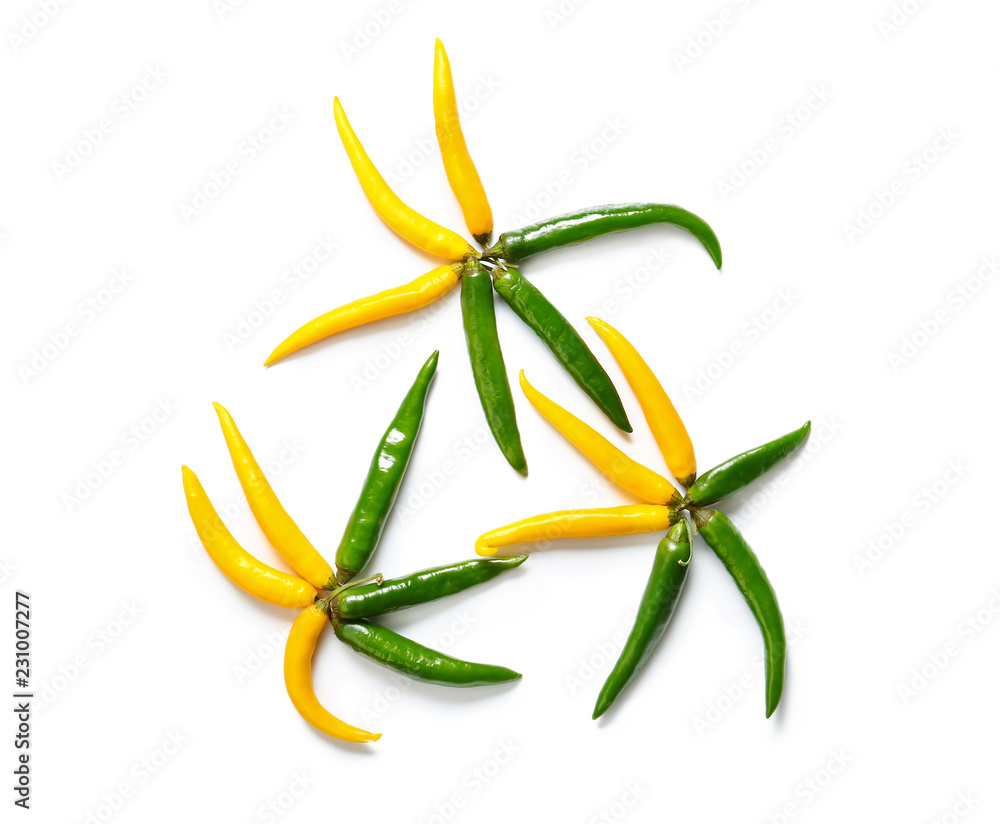 Composition with colorful chili peppers on white background