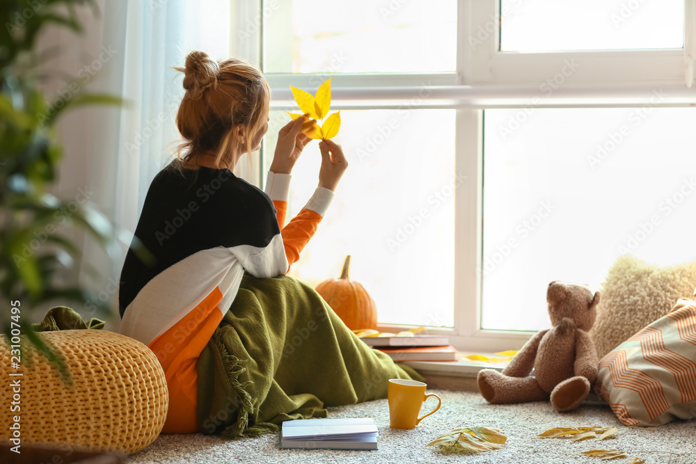 Woman resting at home on autumn day