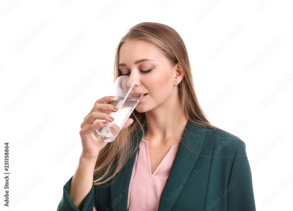 Beautiful young woman drinking water on white background