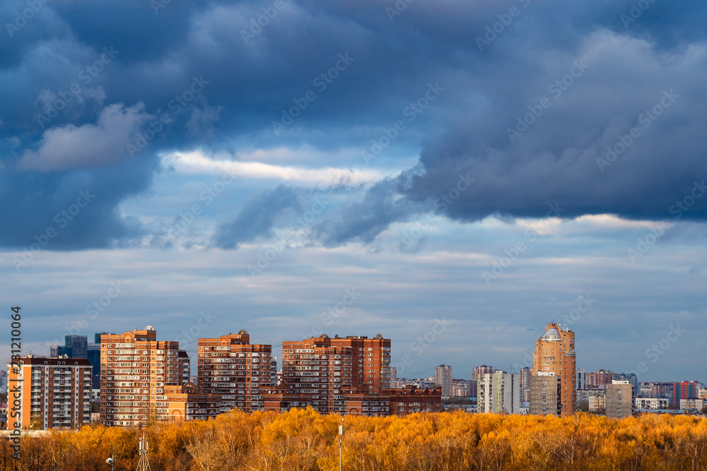 dark blue snow storm clouds over apartment houses