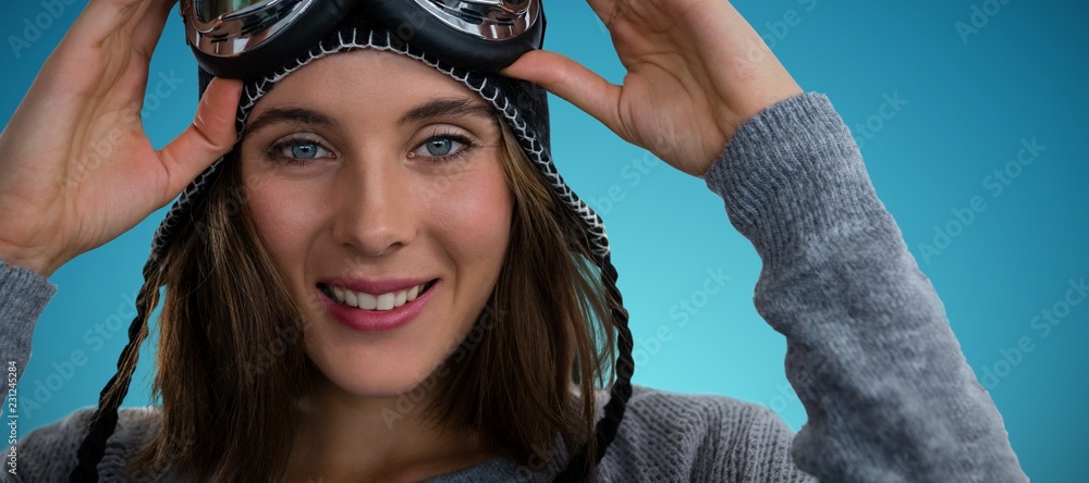 Composite image of portrait of woman with ski goggles