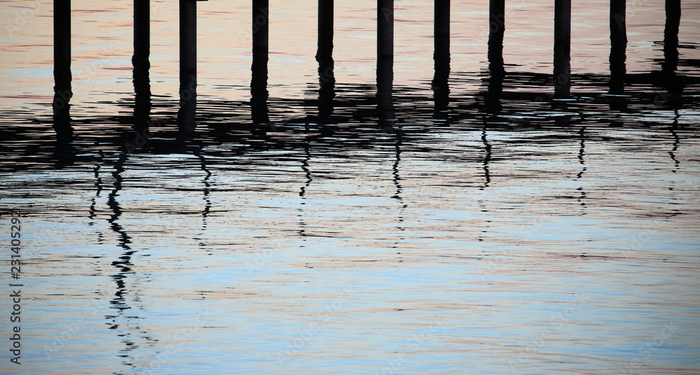 Pier at dusk with water reflections