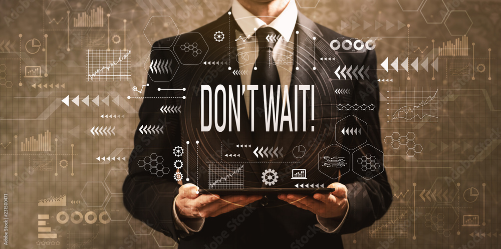 Dont wait with businessman holding a tablet computer on a dark vintage background