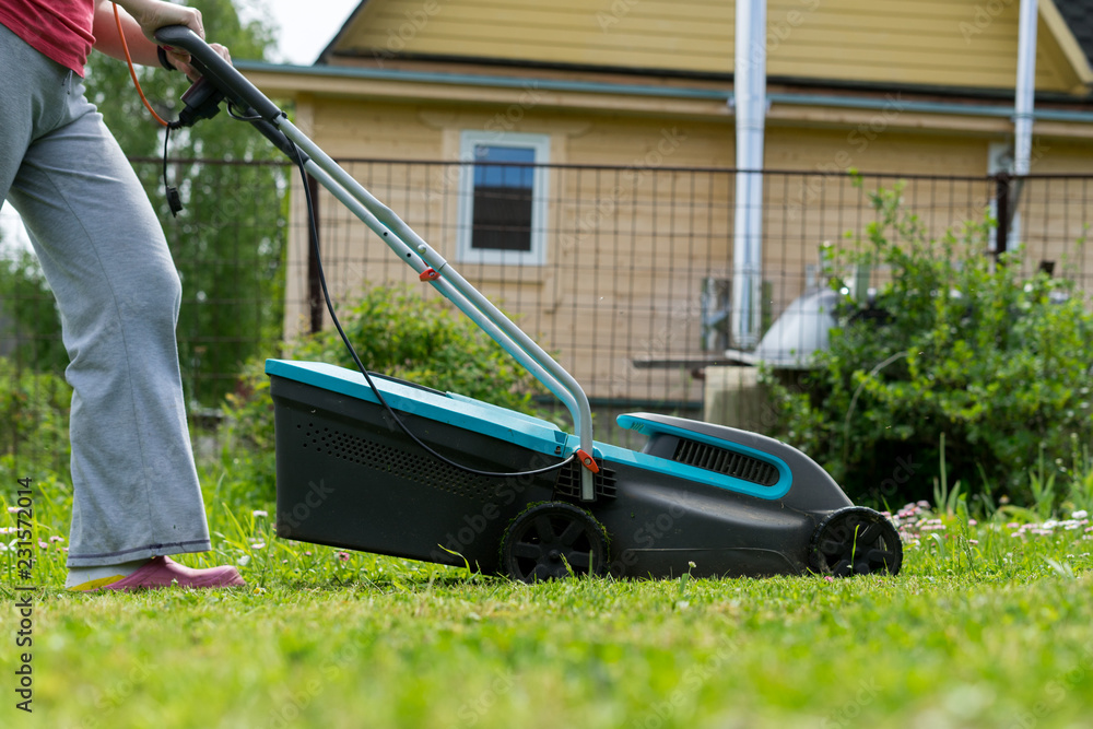 outdoor worker mowing the lawn