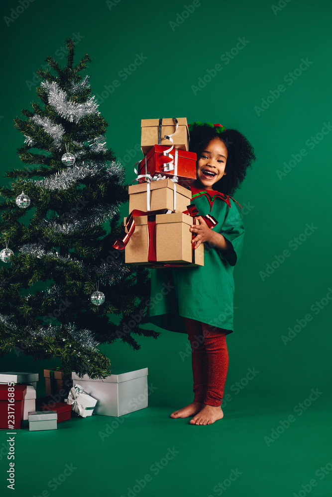 Little girl with her christmas gifts