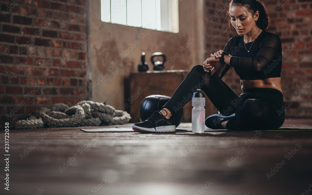 Woman tracking fitness progress on smart phone