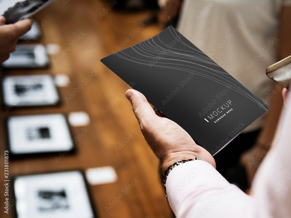 Man holding a brochure mockup in an art gallery