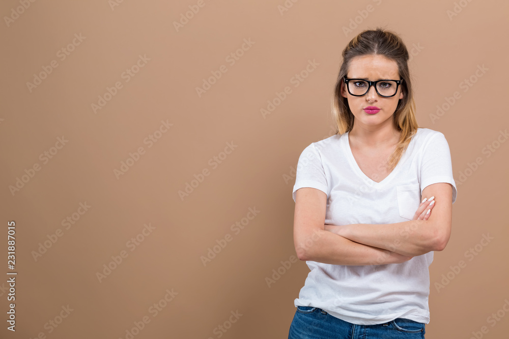 Angry young woman on a brown background