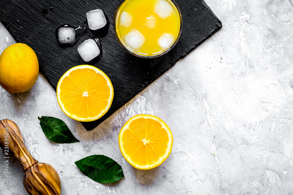 freshly squeezed orange juice on concrete background top view