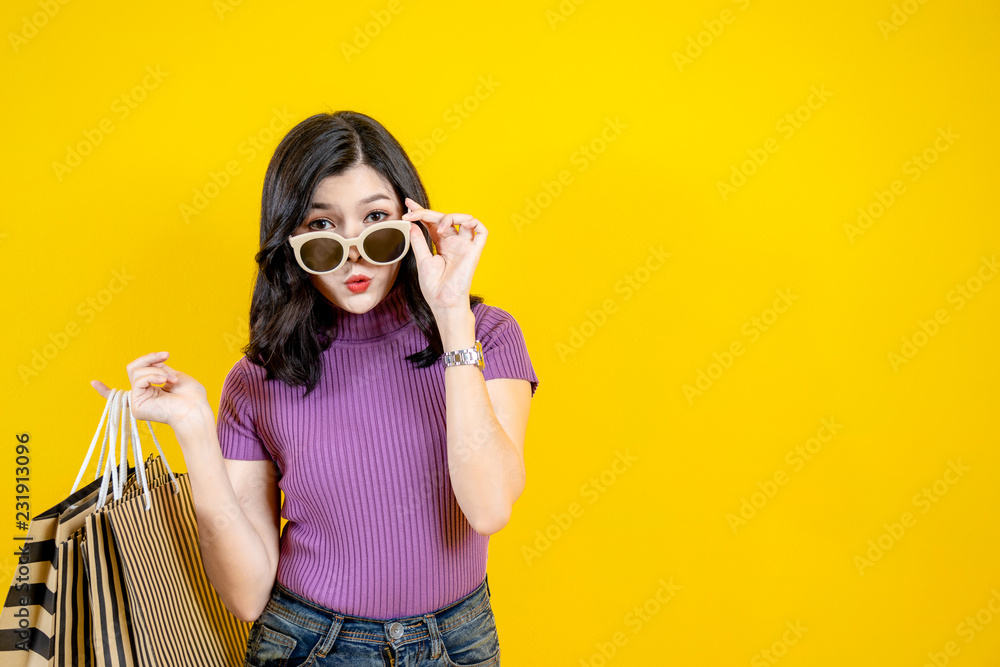 Shopping Woman concept, portrait or isolated an beautiful Asian woman wearing dress, hat and sunglas