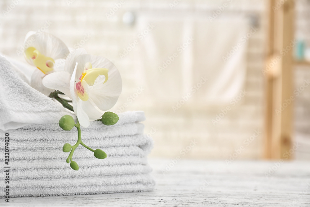 Towels with flowers on light table