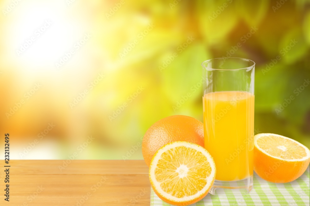 Orange juice and slices of orange on background