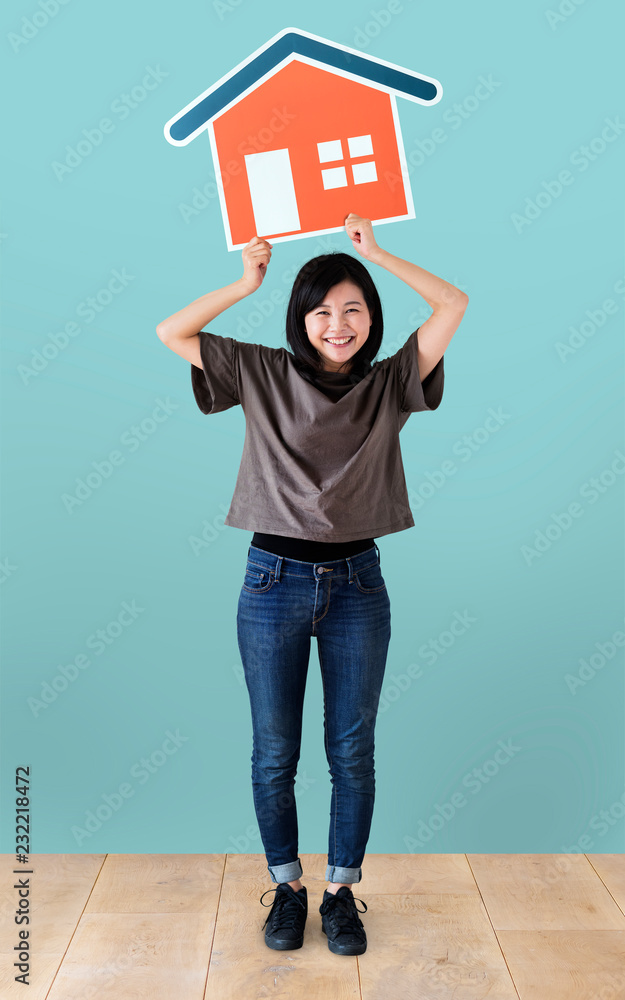 Cheerful woman holding a house icon