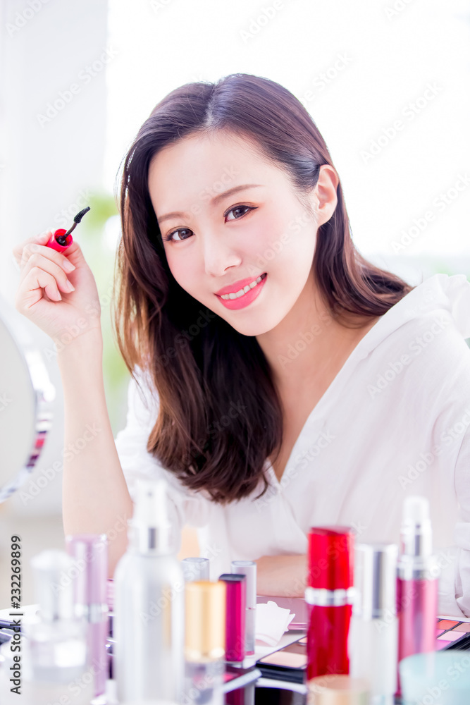 Woman using mascara brush