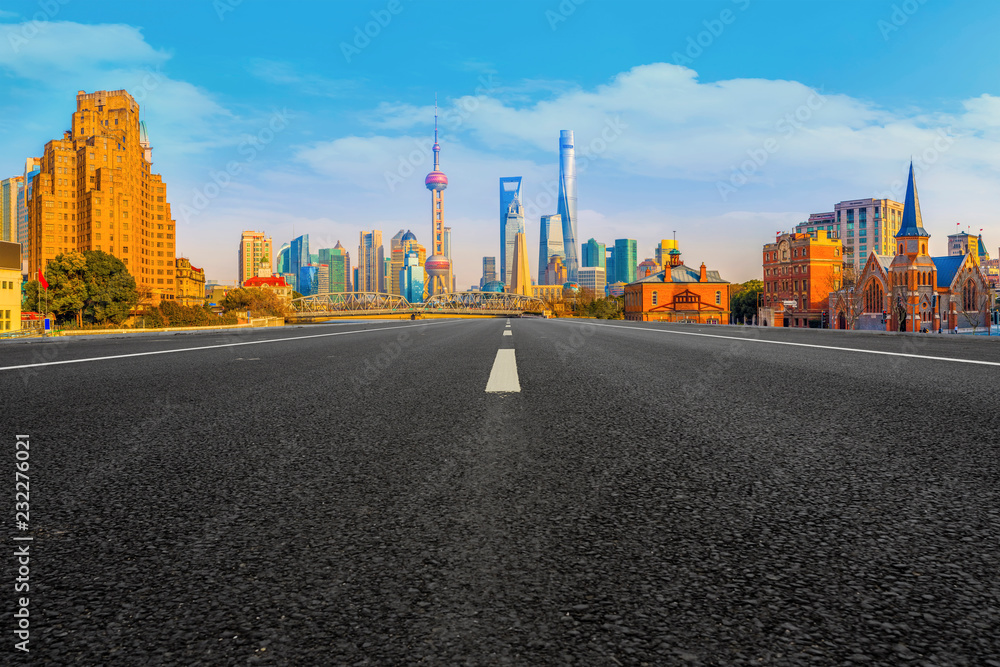 Empty asphalt road along modern commercial buildings in Chinas cities