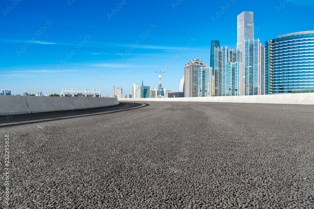 Empty asphalt road along modern commercial buildings in Chinas cities