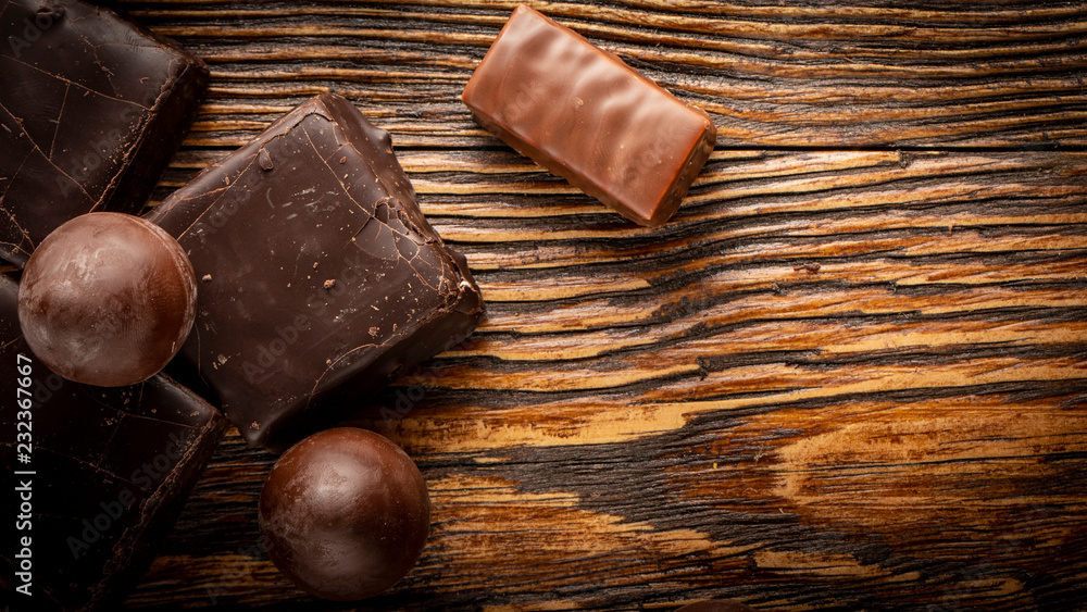 Chocolate candies on a wooden background. Close-up