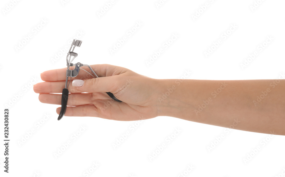 Woman holding eyelash curler on white background