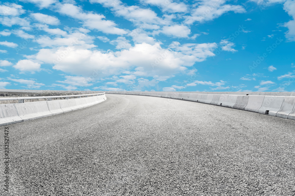 Empty asphalt road and natural landscape under the blue sky