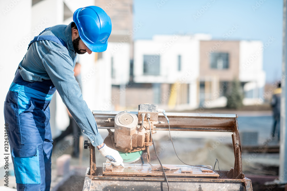 户外施工现场用大电锯均匀切割瓷砖的建设者