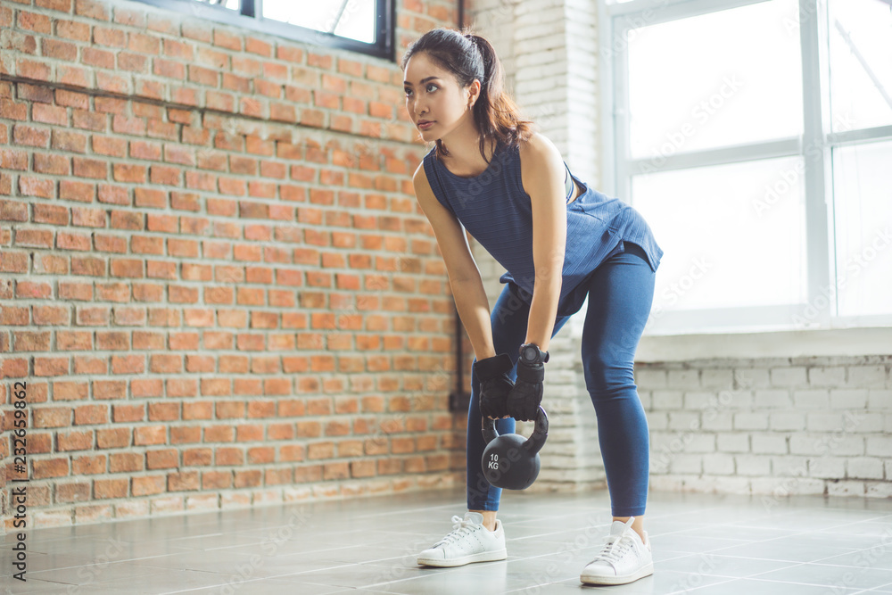 Asian woman exercise indoors she acted the squash