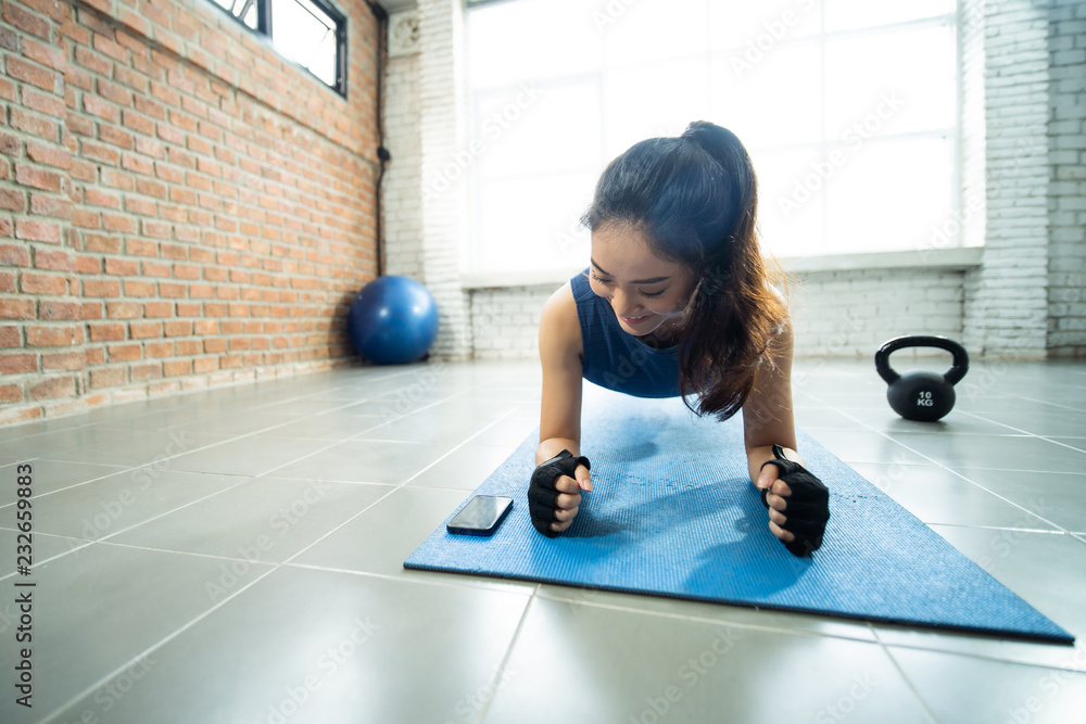 Asian women exercising in the gym, she was pretending to plank