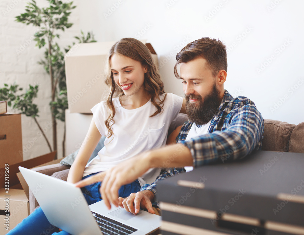 happy young married couple moves to new apartment