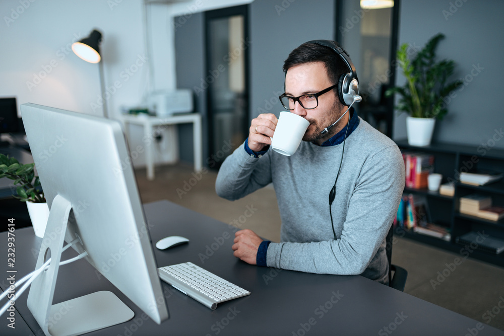 Attractive support center agent taking a coffee break after call.