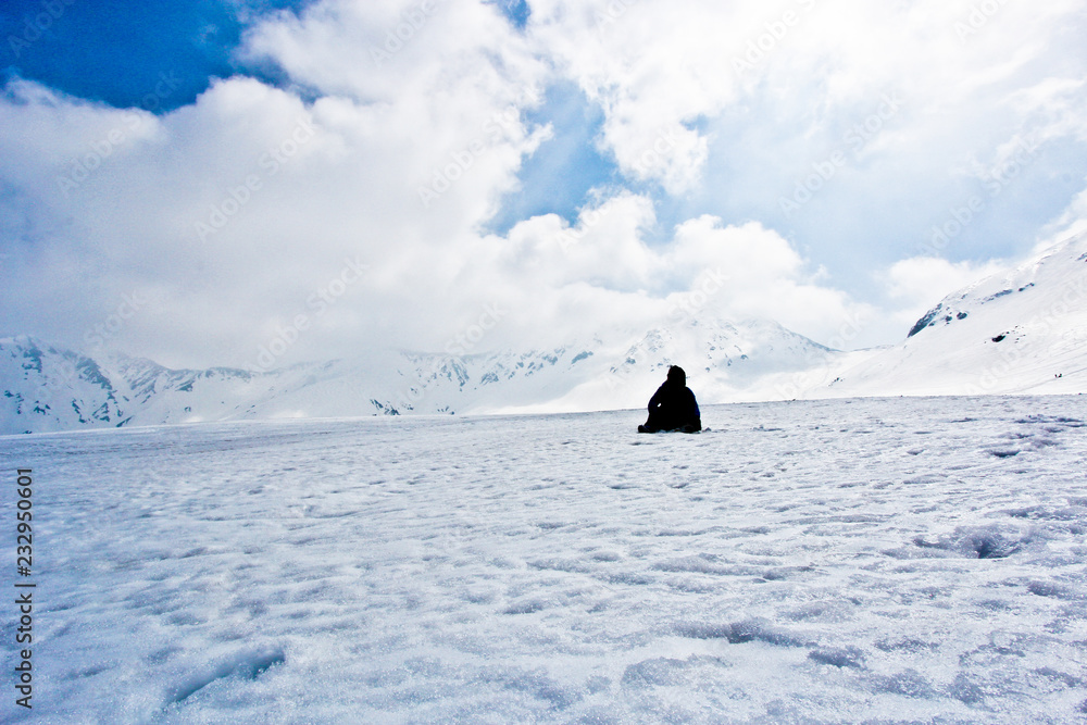 silhouette man sit on snow hill