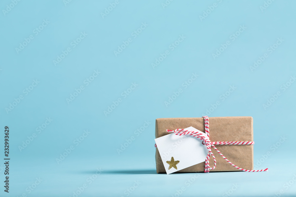 Present box with tag on a blue background