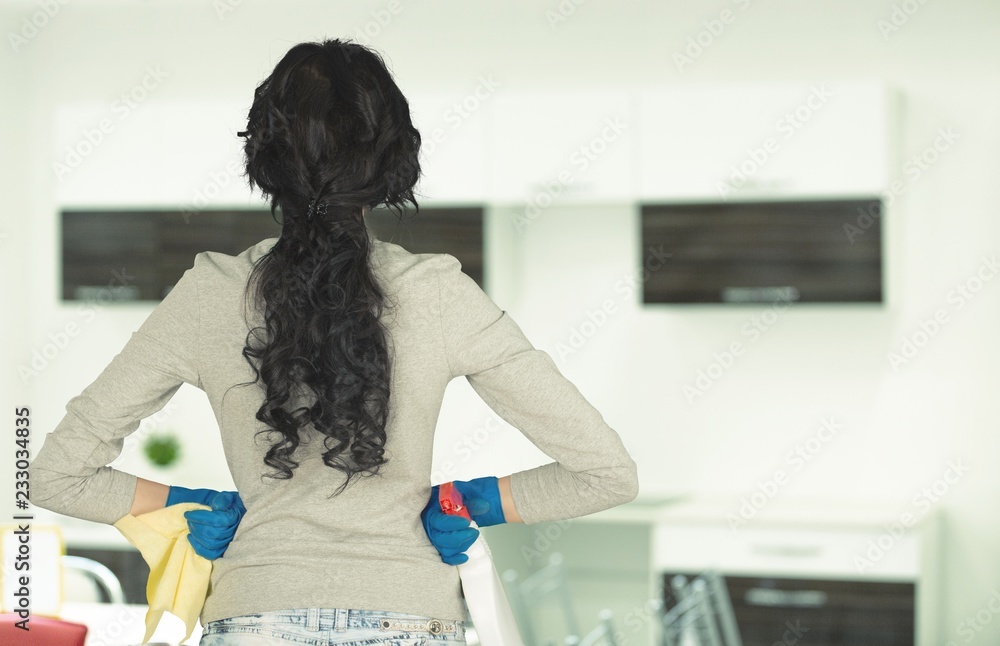 Woman with cleaning supplies on interior background