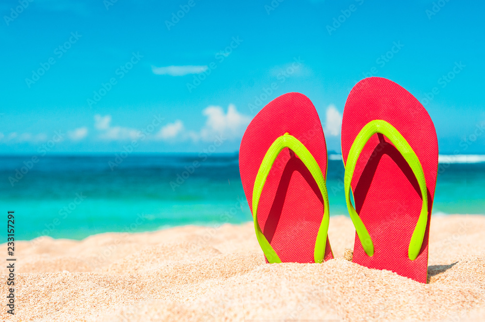 Beautiful beach. Beach sandals on the sandy coast. Summer holiday and vacation concept. Tropical bea