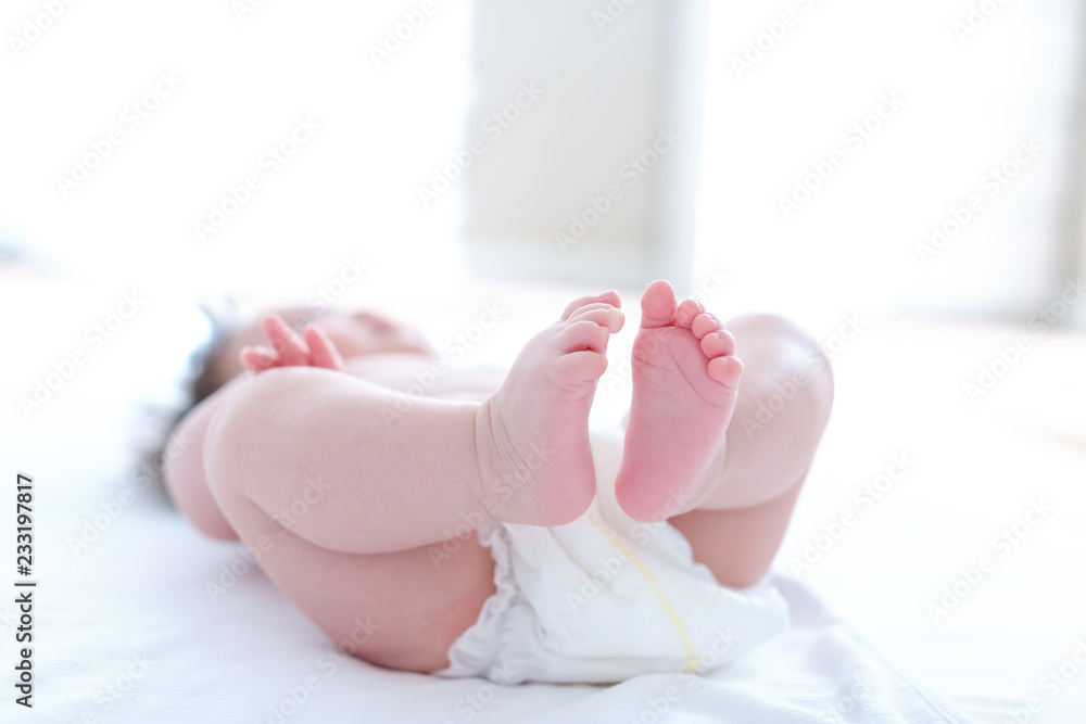 The feet of a young baby boy - no face