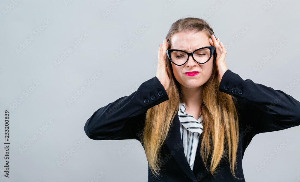 年轻女性在灰色背景下感到压力