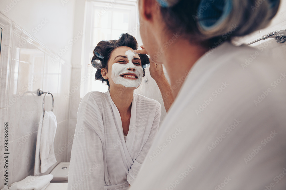 Close up of a woman applying face cream to another woman