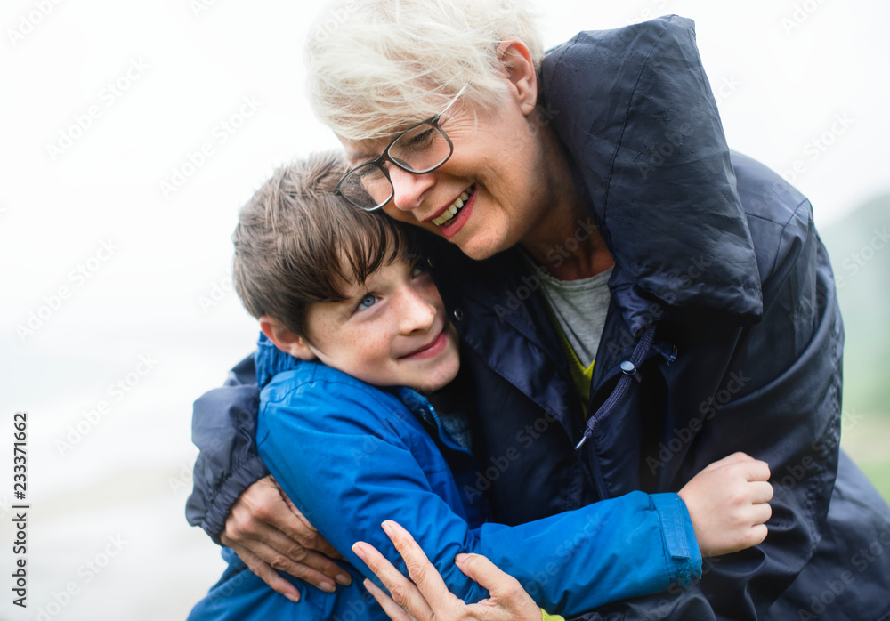 Happy grandmother hugging her grandson