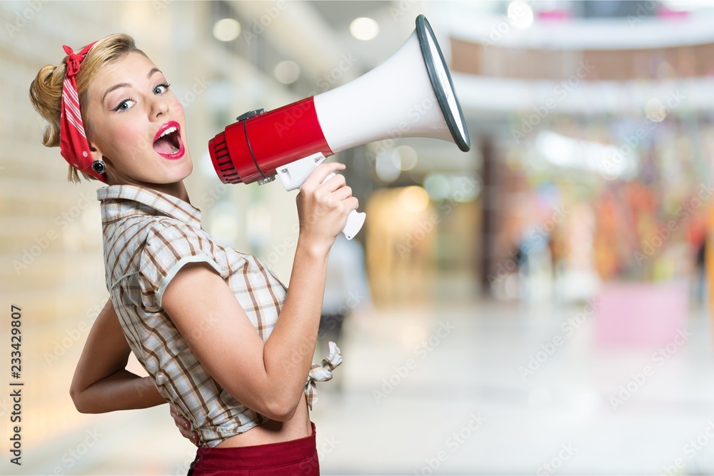 Portrait of woman holding megaphone, dressed in pin-up style