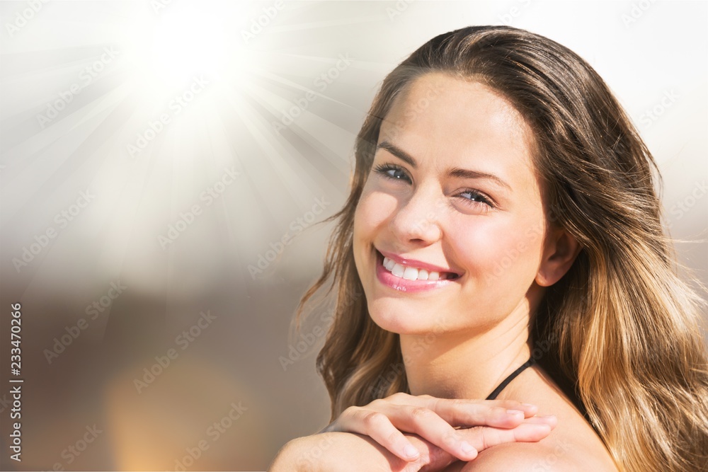 Young relaxed woman on blurred nature background