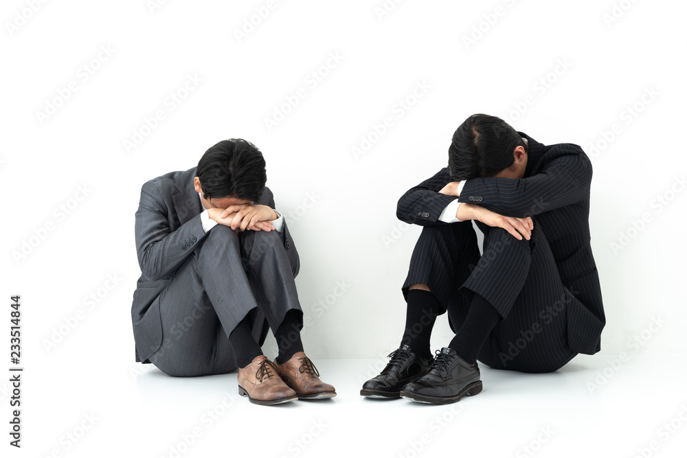 sad business group sitting on white background