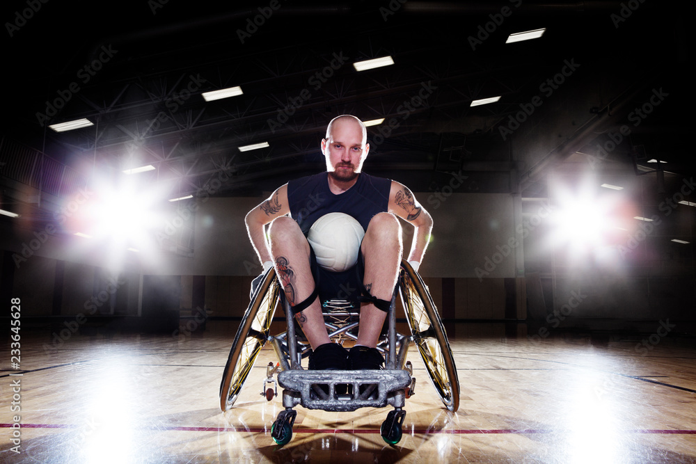 Portrait of confident athlete sitting on wheelchair in court