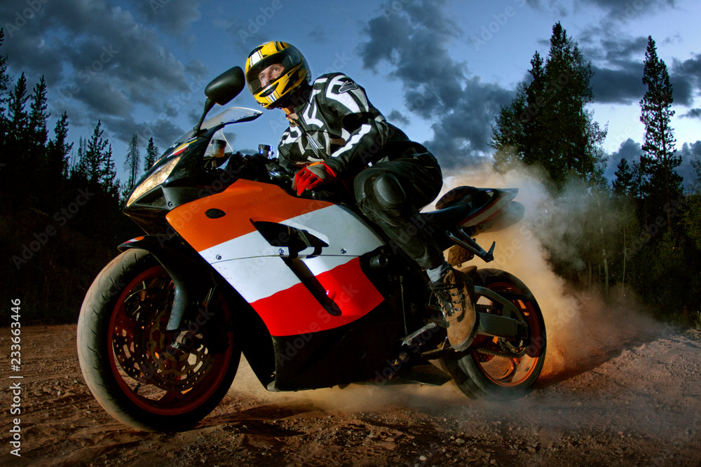 Man riding motorbike against sky at dusk