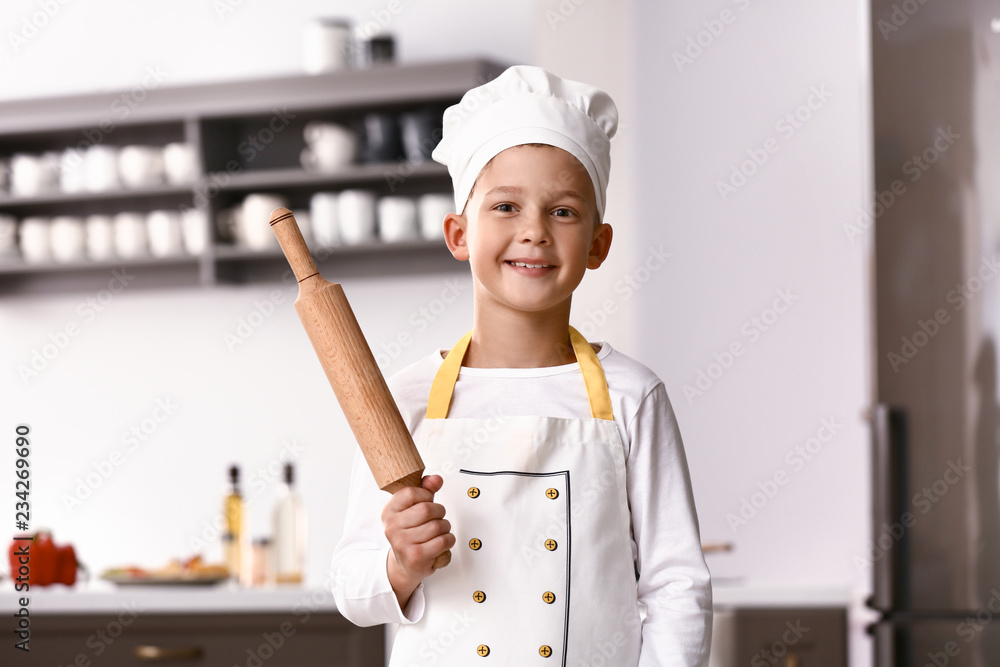 Cute little chef in kitchen