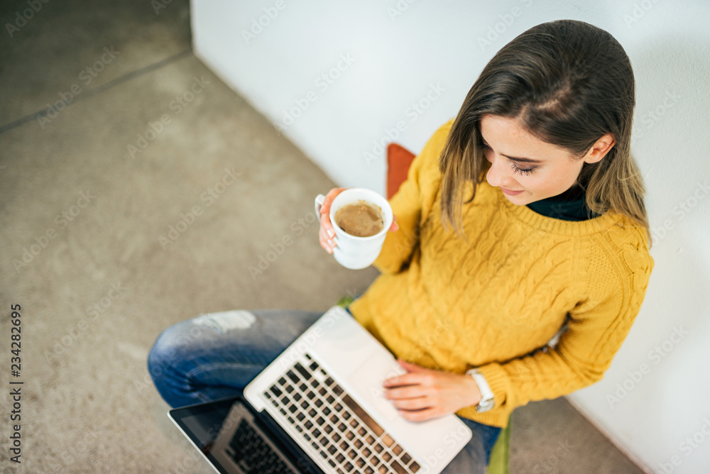 Young woman working on laptop. Top view.