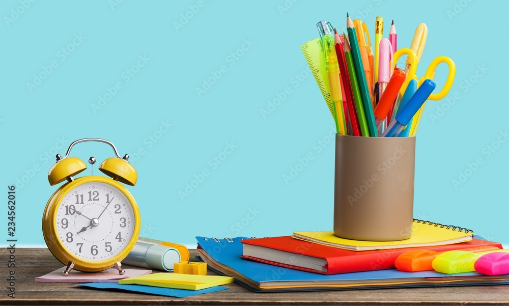 Stationery objects in mini supermarket cart on  background